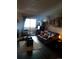 Spacious living room with a leather couch and sliding glass door to balcony at 3100 S Federal Blvd # 203, Denver, CO 80236