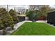 Picture of a well-kept backyard featuring green grass, a small table with chairs, and a black fence at 640 N Magnolia St, Denver, CO 80220