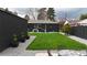 Charming backyard with lush grass, defined garden beds and stylish outdoor seating at 640 N Magnolia St, Denver, CO 80220