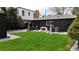 Spacious backyard with green lawn, manicured garden beds, and outdoor grilling area at 640 N Magnolia St, Denver, CO 80220