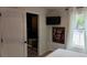 This bedroom has a TV, a Gathering portrait, and an ensuite bathroom with black shower tiles and patterned floor at 640 N Magnolia St, Denver, CO 80220