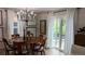 Bright dining room featuring a wooden table, chandelier lighting and sliding glass doors at 640 N Magnolia St, Denver, CO 80220