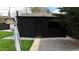 A black brick detached garage with a single door and an arched window, showing a clean, modern design at 640 N Magnolia St, Denver, CO 80220