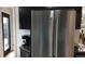 Stainless steel refrigerator blending with black cabinets and countertops for a modern look at 640 N Magnolia St, Denver, CO 80220