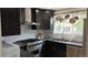 Modern kitchen with stainless steel appliances, dark cabinetry, and a bright, airy feel at 640 N Magnolia St, Denver, CO 80220