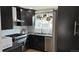 Stylish kitchen featuring sleek black cabinets, stainless steel appliances, and modern finishes at 640 N Magnolia St, Denver, CO 80220