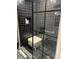 Modern shower with black tiles, glass enclosure, patterned floors, and white stool seating at 640 N Magnolia St, Denver, CO 80220