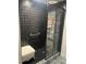 Beautiful shower with black tiles, a glass door, patterned floors, a grab bar, and a white stool at 640 N Magnolia St, Denver, CO 80220