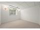 View of the carpeted basement with a window and lights at 3712 Wolff St, Denver, CO 80212