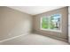 Cozy bedroom featuring a large window, neutral walls, and carpeted floors at 3712 Wolff St, Denver, CO 80212