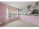 Bright bedroom with a large window, pink walls, and a nature themed mural at 3712 Wolff St, Denver, CO 80212