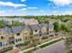 Aerial view of townhomes with gray roofs nestled among lush greenery and tree canopies, close to downtown at 3712 Wolff St, Denver, CO 80212