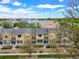Aerial view showcases modern townhomes with gray roofs and manicured landscaping, close to downtown at 3712 Wolff St, Denver, CO 80212