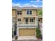 Two story townhome with neutral siding, a front deck, and a two car garage at 3712 Wolff St, Denver, CO 80212