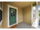 Charming front porch featuring a bright green door and welcoming 'Hello' doormat at 3712 Wolff St, Denver, CO 80212