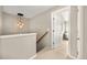 Bright hallway featuring contemporary light fixture, neutral walls, and access to other rooms at 3712 Wolff St, Denver, CO 80212