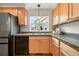 Kitchen featuring stainless steel appliances, wooden cabinets, and a view through the window at 3712 Wolff St, Denver, CO 80212