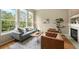 Bright living room with large windows, modern furniture, and hardwood floors at 3712 Wolff St, Denver, CO 80212
