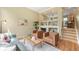 Warm living room with modern furniture, fireplace, and open layout to kitchen at 3712 Wolff St, Denver, CO 80212
