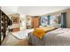 Large, airy bedroom featuring blue curtains, an open closet, and a cozy sofa at 3706 E Easter Dr, Centennial, CO 80122
