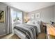 Bright bedroom featuring a sunny window with sheer curtains, neutral walls, and soft carpet at 3706 E Easter Dr, Centennial, CO 80122