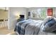 Bedroom with a bed, dresser and TV on the wall next to a large bright window at 3706 E Easter Dr, Centennial, CO 80122