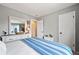 Neutral bedroom featuring bright light, a dresser, and a large built-in mirror at 3706 E Easter Dr, Centennial, CO 80122
