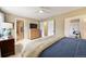 Comfortable bedroom featuring neutral colors, ceiling fan and closet and bathroom doors at 3706 E Easter Dr, Centennial, CO 80122