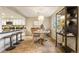 Charming dining area features a unique chandelier, modern furniture, and open access to a kitchen with an island and plenty of counter space at 3706 E Easter Dr, Centennial, CO 80122