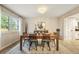 Dining room featuring hardwood flooring, elegant chandelier, decor, and backyard view at 3706 E Easter Dr, Centennial, CO 80122
