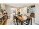 Traditional dining room featuring a large wooden table, neutral walls, and access to the staircase and kitchen for easy entertaining at 3706 E Easter Dr, Centennial, CO 80122