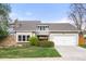 Charming home featuring manicured lawn, attached two-car garage, mature trees and unique entryway at 3706 E Easter Dr, Centennial, CO 80122