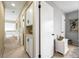 Hallway with white woodwork featuring a built-in cabinet and decor and artwork at 3706 E Easter Dr, Centennial, CO 80122