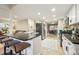Modern kitchen with stainless steel appliances, a breakfast bar, and an open layout provides a seamless transition to the living and dining areas at 3706 E Easter Dr, Centennial, CO 80122