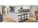 Bright kitchen with black countertops, white cabinets, and a breakfast bar offers a sleek design and plenty of space for cooking and dining at 3706 E Easter Dr, Centennial, CO 80122