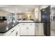 The kitchen has a stainless steel dishwasher and provides clear sight lines to the living area and outside to create a connected living space at 3706 E Easter Dr, Centennial, CO 80122