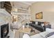 Open living room featuring vaulted ceilings, a cozy fireplace, and access to the staircase at 3706 E Easter Dr, Centennial, CO 80122