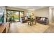 Well-lit living room features large sliding glass doors, plush sofas, and elegant decor that provides a welcoming and relaxing atmosphere at 3706 E Easter Dr, Centennial, CO 80122