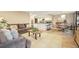 Open-concept living area includes a comfortable sofa, a dining area, and a kitchen with bar seating, ideal for entertaining and everyday living at 3706 E Easter Dr, Centennial, CO 80122