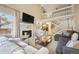 Cozy living room showcasing a fireplace, a balcony, vaulted ceilings, and natural light at 3706 E Easter Dr, Centennial, CO 80122