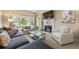 Relaxing living room with fireplace, neutral paint, mantel decorations, and large windows at 3706 E Easter Dr, Centennial, CO 80122