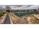 Well-maintained tennis courts with green fencing and landscaping, providing a private and scenic setting at 3706 E Easter Dr, Centennial, CO 80122