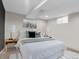 Finished basement bedroom with neutral walls and plush bedding at 1466 Elmwood Ln, Denver, CO 80221