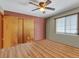 Bedroom with double doors and wood-look floors at 1466 Elmwood Ln, Denver, CO 80221