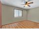 Spacious bedroom with ceiling fan and wood-look floors at 1466 Elmwood Ln, Denver, CO 80221