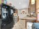 Kitchen with dark brown cabinets, tile backsplash and stainless steel appliances at 1466 Elmwood Ln, Denver, CO 80221