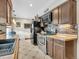 Kitchen boasts dark brown cabinets, tile backsplash, and stainless steel appliances at 1466 Elmwood Ln, Denver, CO 80221