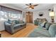 Living room with hardwood floors, two sofas, and a ceiling fan at 1466 Elmwood Ln, Denver, CO 80221