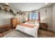 Cozy bedroom with hardwood floors, a warm color palette, and natural light at 10105 Morrison Rd, Lakewood, CO 80227
