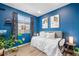 Bedroom featuring a bright blue accent wall, and a lovely view of the outside at 10105 Morrison Rd, Lakewood, CO 80227